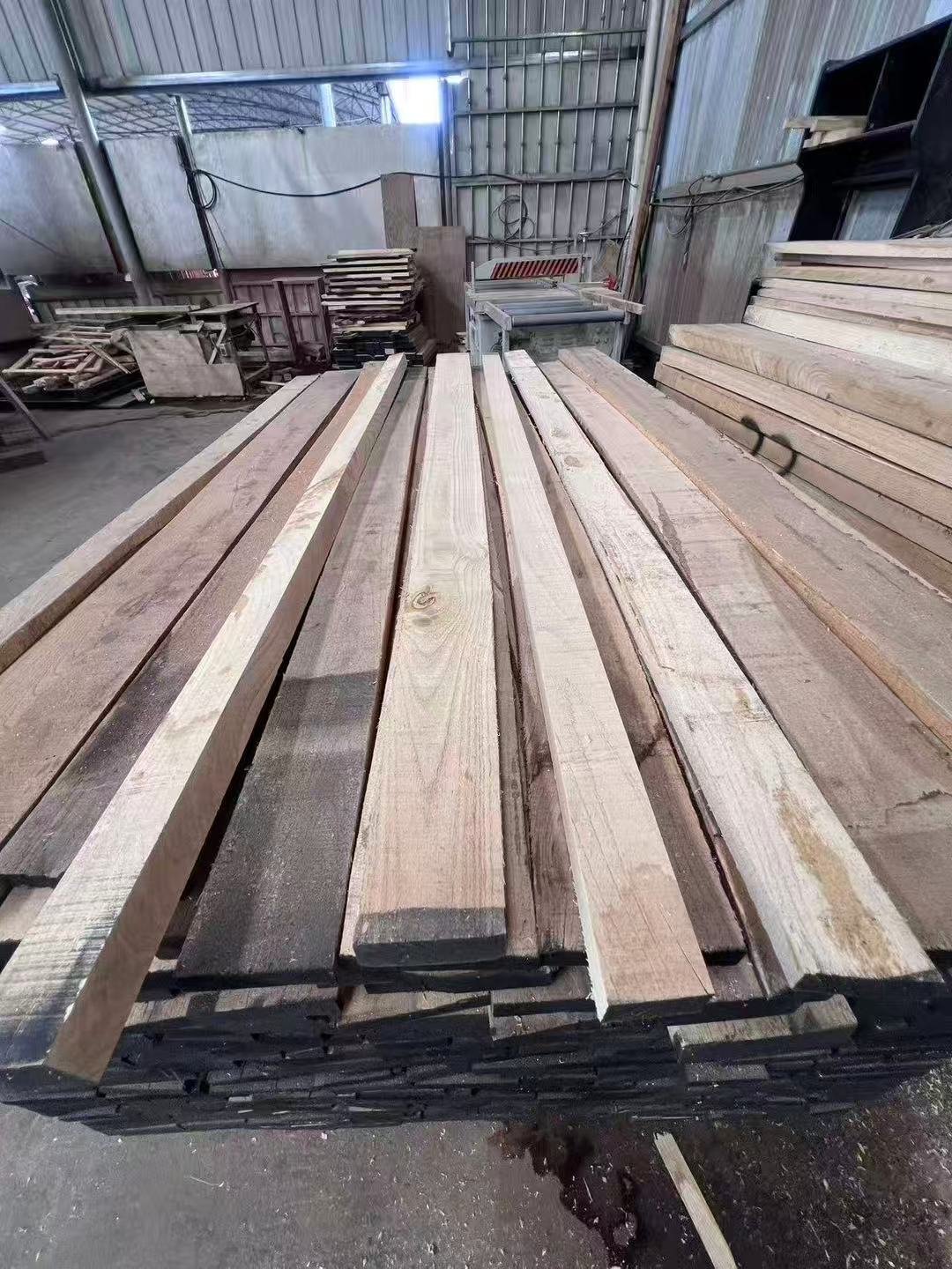 Solid wood stock beside workshop equipment
